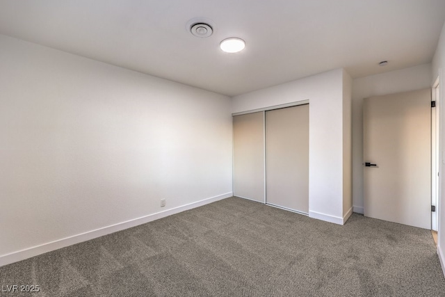 unfurnished bedroom featuring carpet floors and a closet