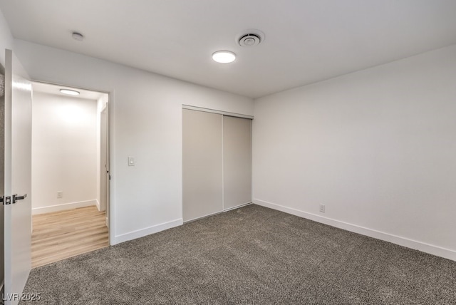 unfurnished bedroom with a closet and carpet