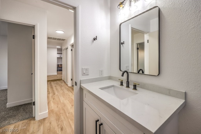 bathroom with wood-type flooring and vanity