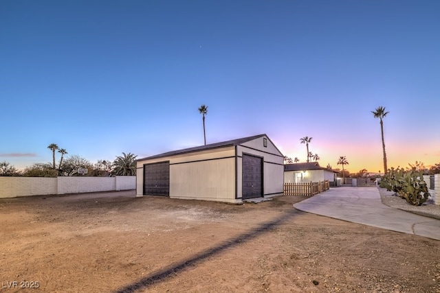 exterior space featuring a garage and an outdoor structure