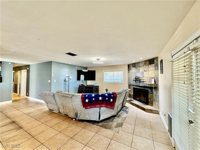 tiled living room featuring a tile fireplace