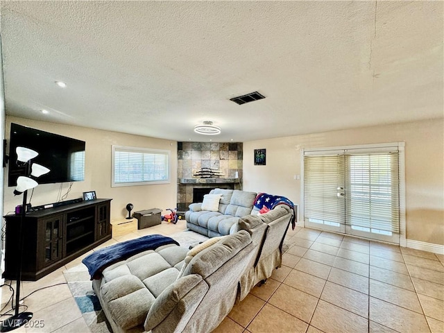 tiled living room featuring a textured ceiling