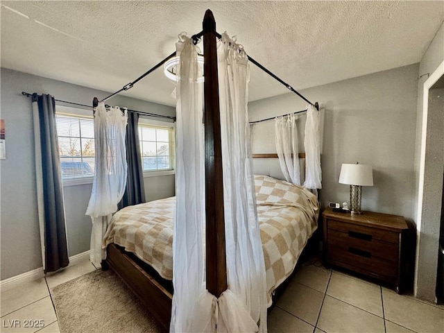 bedroom featuring light tile patterned floors and a textured ceiling