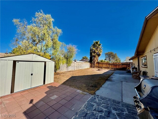 view of patio with grilling area and a storage shed