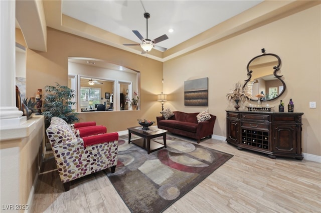 10372 Hawks Wing St, Las Vegas, NV 89178 - living room with ceiling fan, a raised ceiling, and light hardwood / wood-style floors