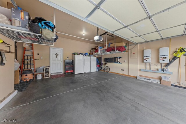 garage with white refrigerator and a garage door opener