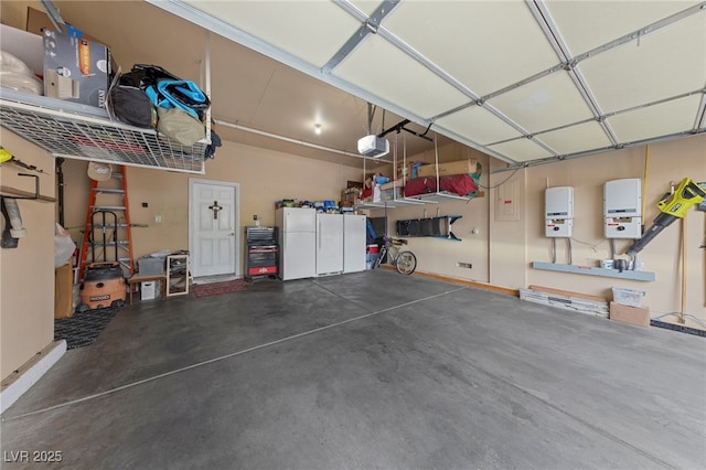 10372 Hawks Wing St, Las Vegas, NV 89178 - garage featuring a garage door opener and white fridge
