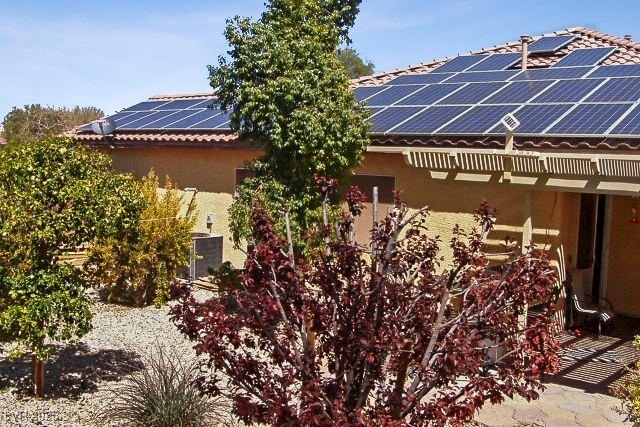 view of side of home with solar panels