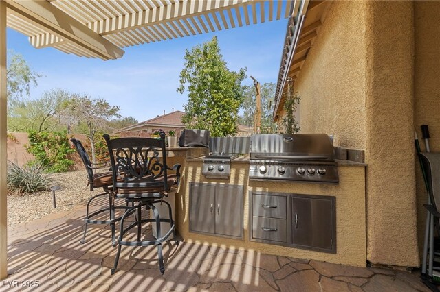 view of patio / terrace featuring an outdoor kitchen, area for grilling, and a pergola