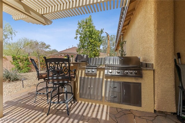 10372 Hawks Wing St, Las Vegas, NV 89178 - view of patio with area for grilling and a pergola