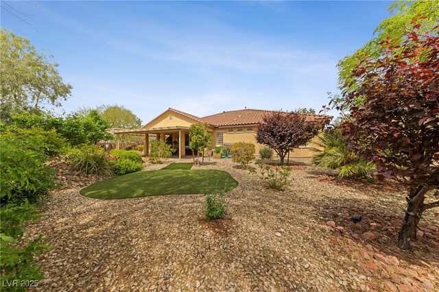 view of front of home with a front lawn and a patio