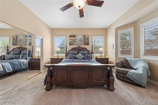 carpeted bedroom with ceiling fan, multiple windows, and a closet