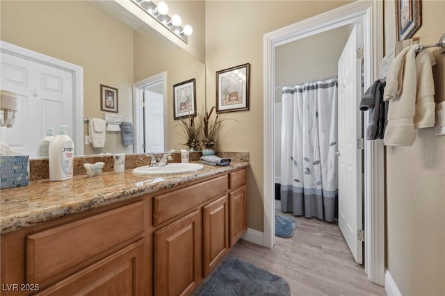 bathroom with vanity, a shower with curtain, and hardwood / wood-style floors