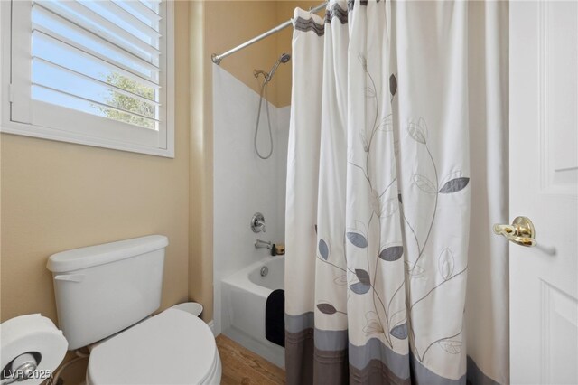 bathroom featuring toilet, shower / tub combo, and wood-type flooring