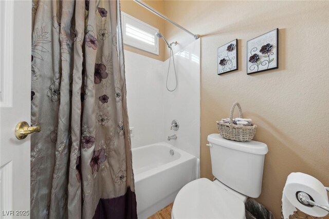 bathroom with toilet and shower / bathtub combination with curtain