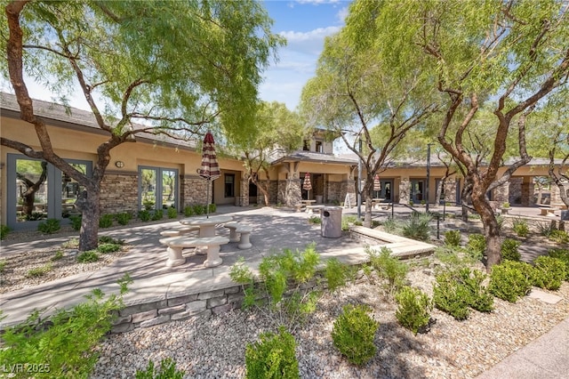 10372 Hawks Wing St, Las Vegas, NV 89178 - back of house featuring a patio area and an outdoor stone fireplace