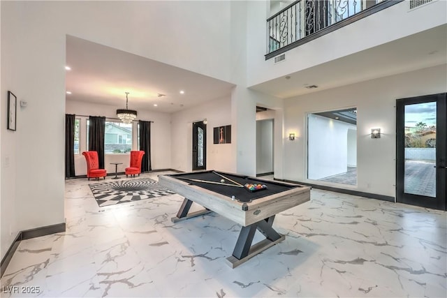 playroom featuring french doors, pool table, and a chandelier