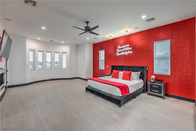 bedroom with ceiling fan and light wood-type flooring