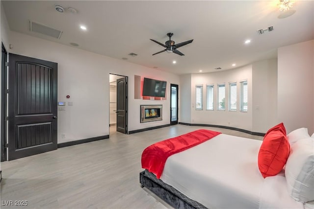 bedroom with ceiling fan and light wood-type flooring