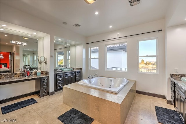 bathroom with vanity, tile patterned floors, and tiled tub