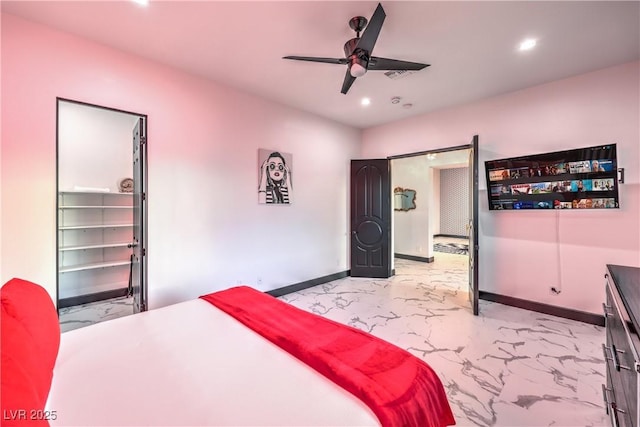 bedroom with a spacious closet, a closet, and ceiling fan