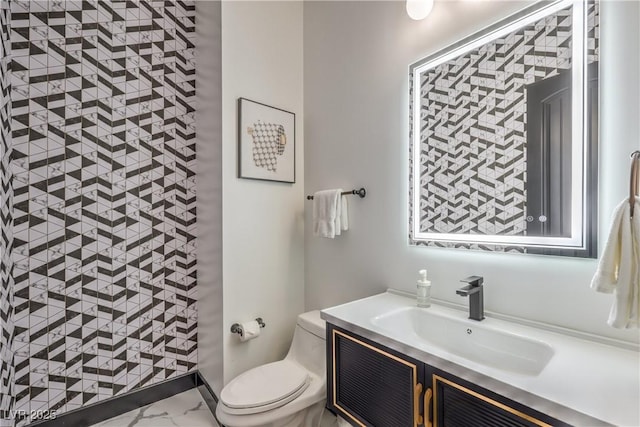 bathroom featuring toilet and vanity