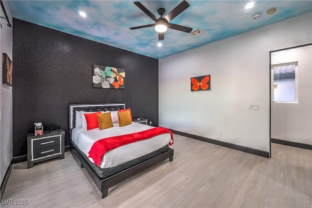 bedroom with ceiling fan and light hardwood / wood-style flooring