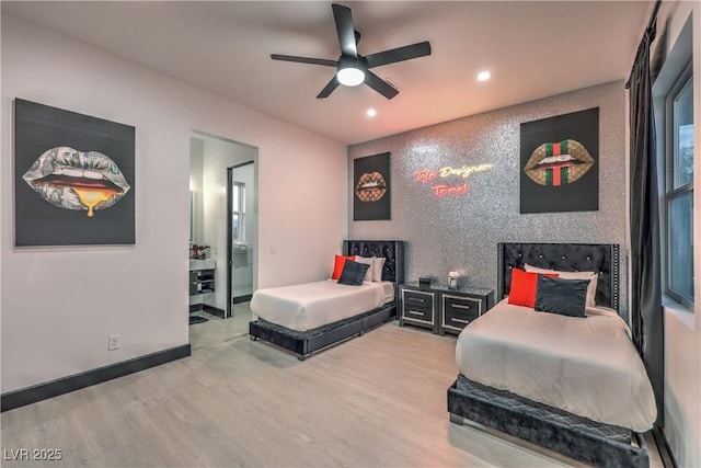 bedroom with ensuite bathroom, ceiling fan, and wood-type flooring