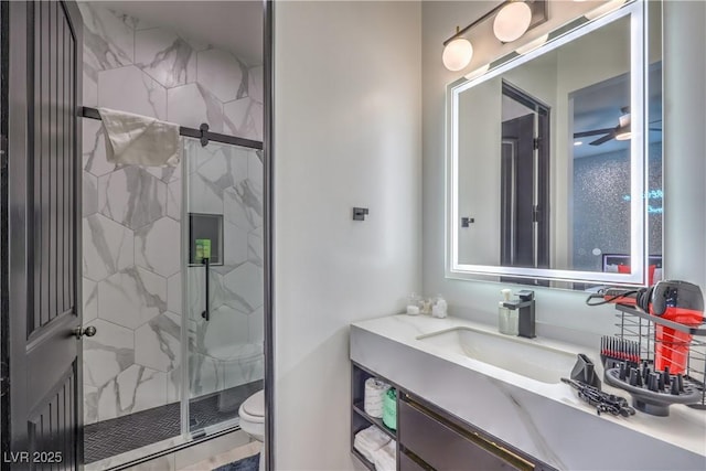 bathroom featuring toilet, vanity, and a shower with door