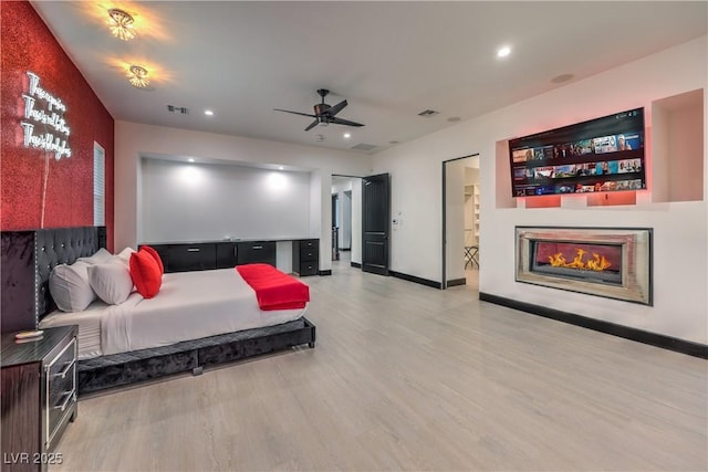 bedroom with ceiling fan and light hardwood / wood-style floors