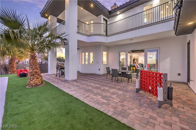 patio terrace at dusk with a lawn