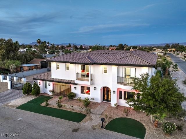 mediterranean / spanish-style house featuring a mountain view and a balcony