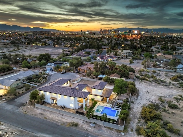 aerial view at dusk featuring a mountain view