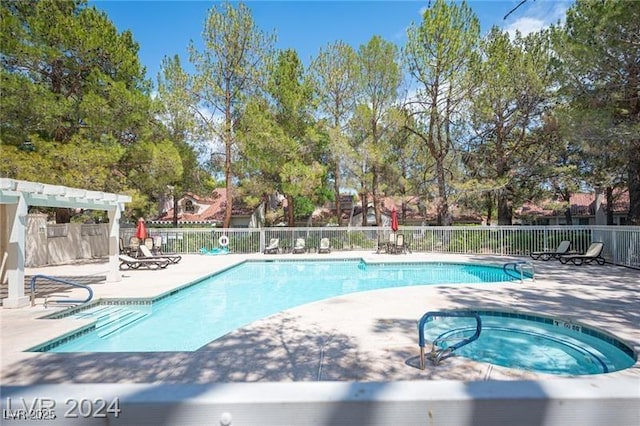 view of pool with a community hot tub and a patio