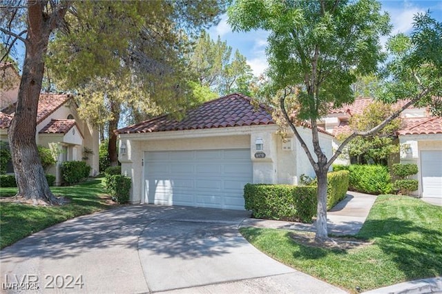 mediterranean / spanish-style home with a garage