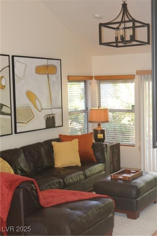 living room featuring a chandelier and vaulted ceiling