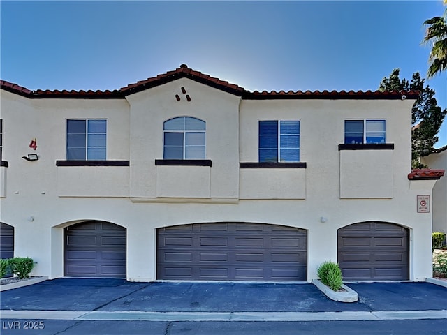 mediterranean / spanish house featuring a garage