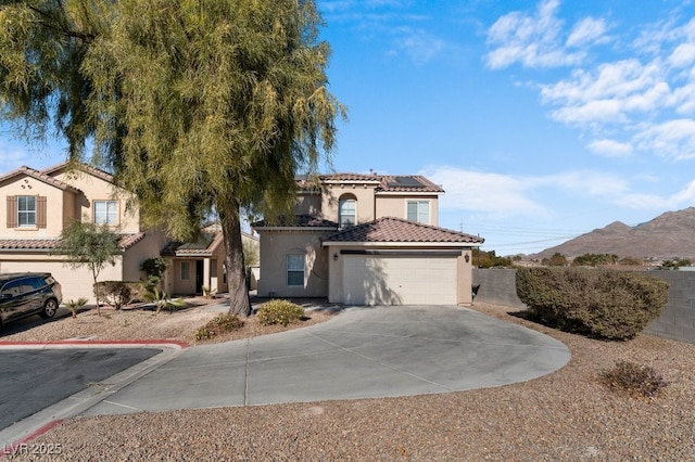 view of front of house with a mountain view and solar panels