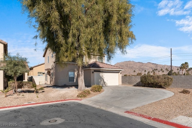 view of front of property with a mountain view and a garage