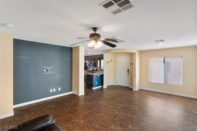 unfurnished living room with ceiling fan