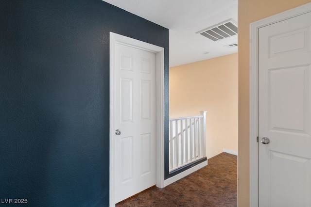 hallway with dark carpet