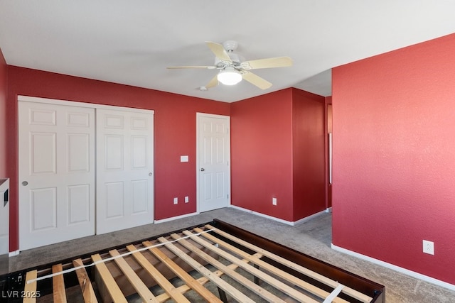 unfurnished bedroom with ceiling fan, a closet, and carpet floors