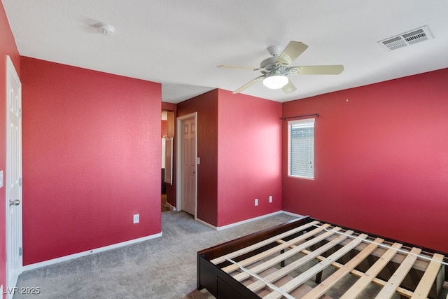 unfurnished bedroom featuring ceiling fan and carpet floors