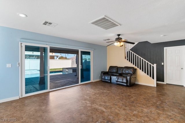 unfurnished living room featuring ceiling fan