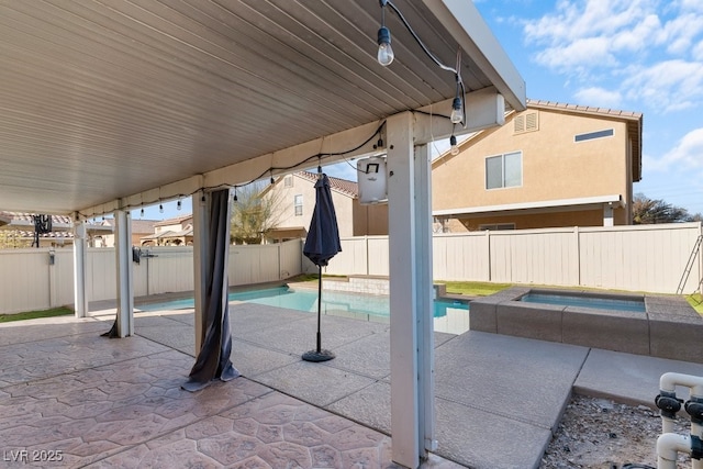 view of patio / terrace featuring a pool with hot tub