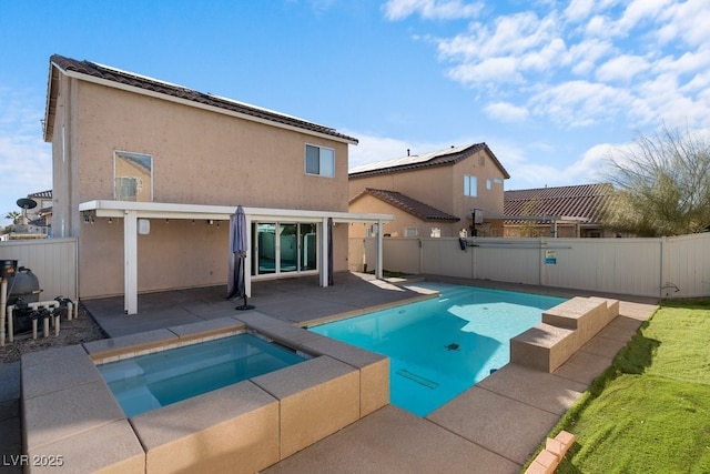 view of pool featuring a patio area and an in ground hot tub