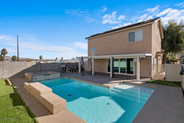 view of pool with a patio area and an in ground hot tub