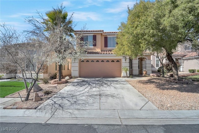 view of front of home featuring a tile roof, stucco siding, concrete driveway, and a garage