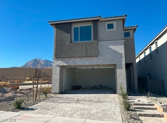 exterior space featuring a garage and a mountain view