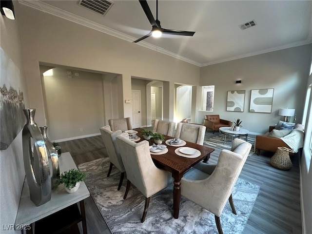 dining space featuring ceiling fan, dark hardwood / wood-style flooring, and crown molding